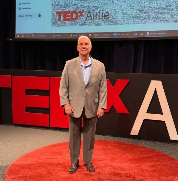 Neil Taft on TEDx Airlie stage in preparation for his speech titled: The Bridge To Your Children.